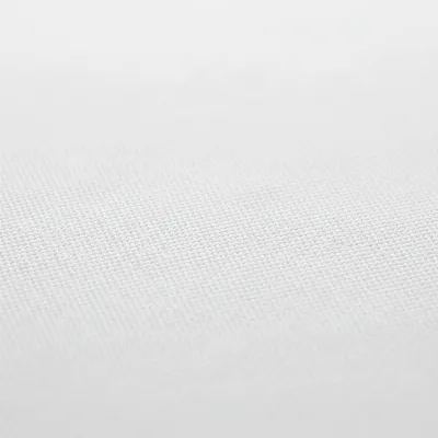 A close-up, highly detailed view of a matte white projector screen fabric surface, showing its fine texture and how light is evenly diffused across it, illustrating screen material quality.